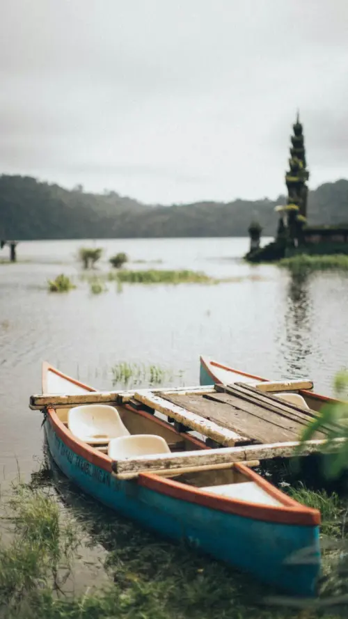 Boat on a lake in Indonesia with a temple