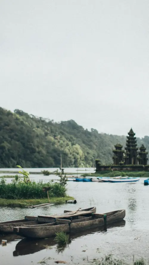 Boat on a lake with a temple wallpaper HD 4K for phone