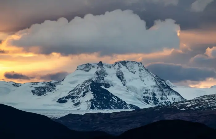 Snow-capped mountain at sunset
