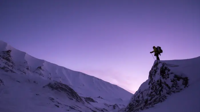 Purple sky over snow-covered mountains