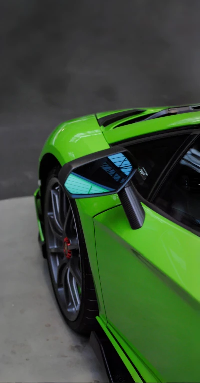 Green Lamborghini Aventador against a modern background
