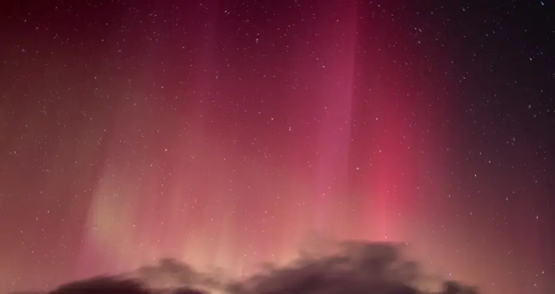 Red aurora borealis in the middle of the night