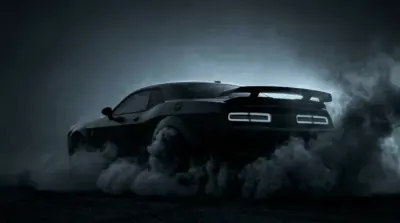 Black muscle car drifting, smoke on a dark background