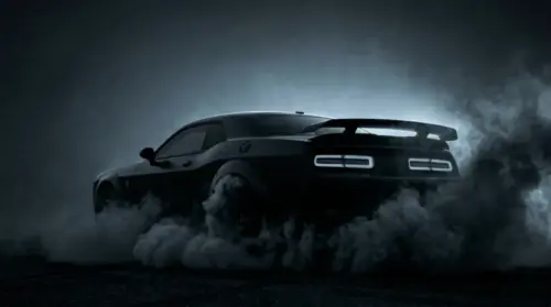 Black muscle car drifting, smoke on a dark background