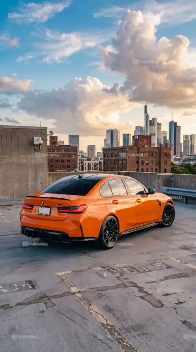 Orange BMW M3 and city at sunset