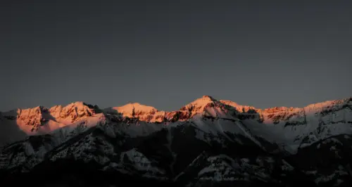 Sunset glow on the snow-covered mountains wallpaper HD 4K for desktop