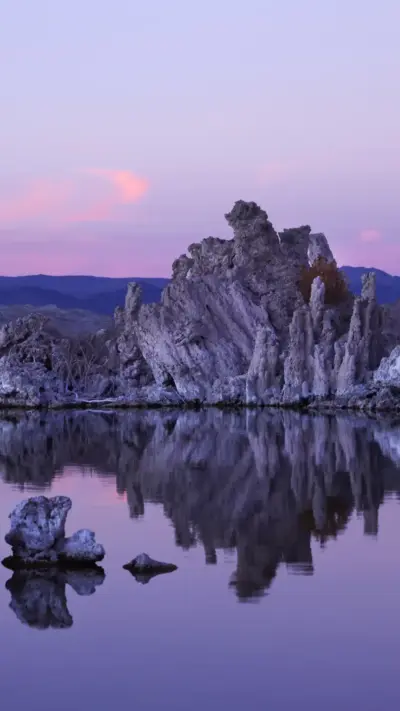 Rock with reflection of the lake and sunset