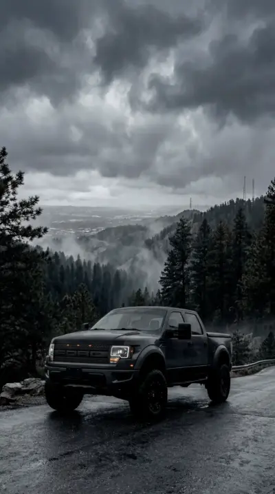 Ford Raptor in the mountains under a stormy sky
