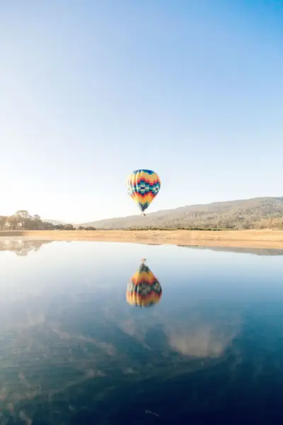 Colorful hot air balloon reflected on the lake a soothing landscape