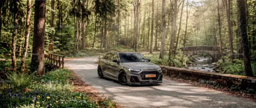 A grey Audi RS4 on a forest road
