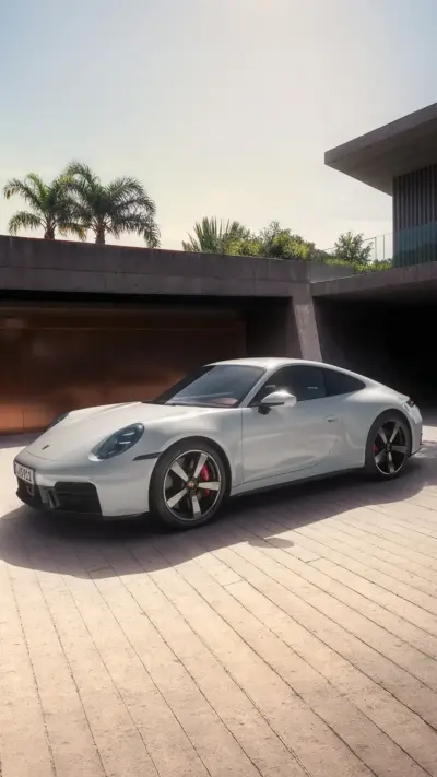 Grey Porsche 911 in front of a modern villa