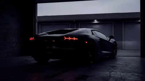 Black Lamborghini in a garage at night