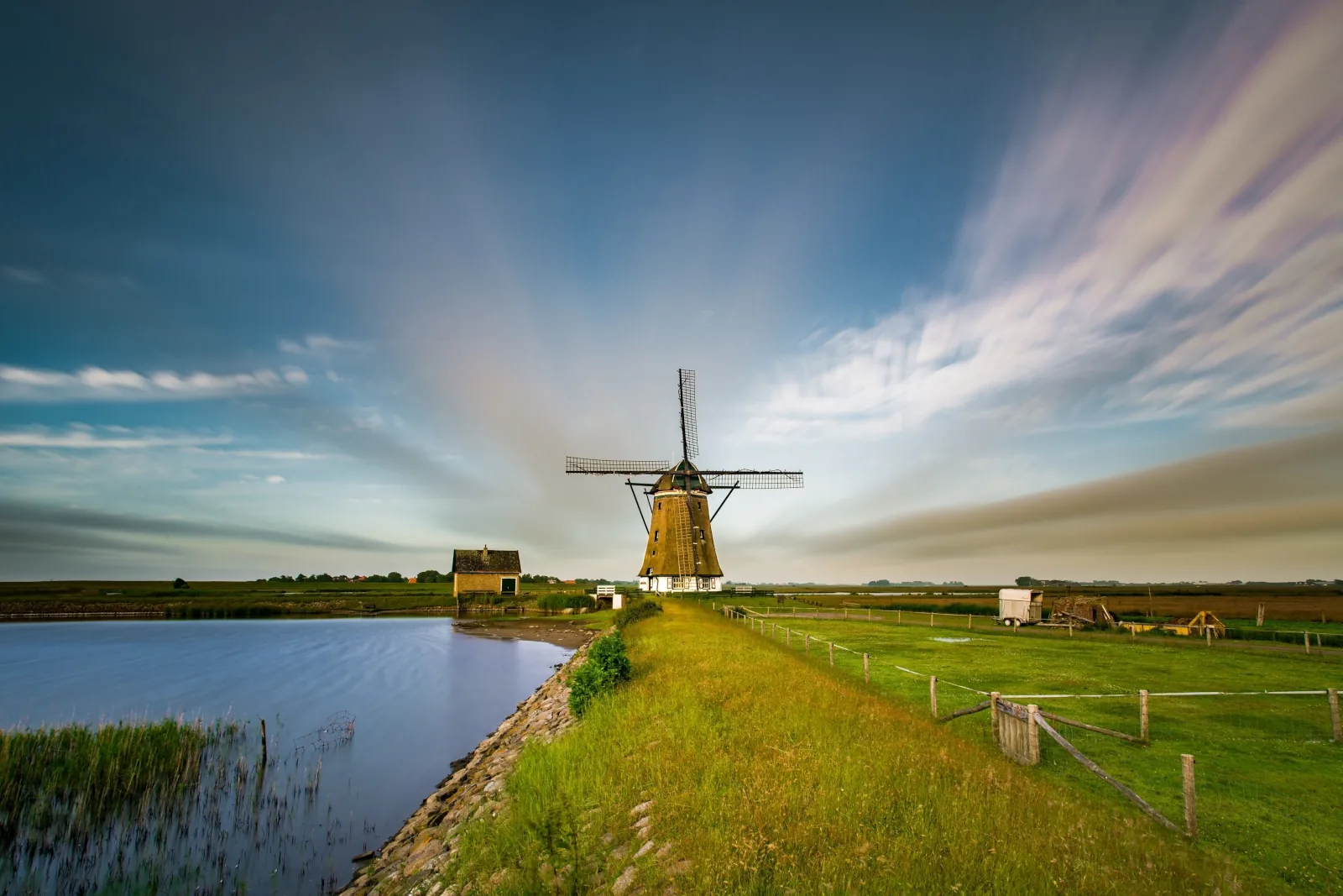 Traditional windmill by the water wallpaper HD 4K for desktop