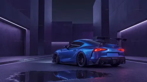 Blue Toyota Supra under purple neon lights